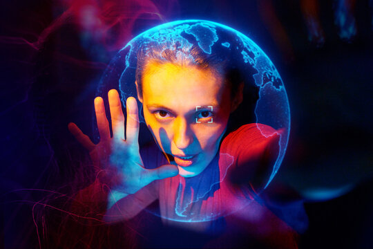 Woman in virtual reality with holographic globe interface