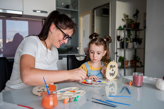 Mother and daughter create Halloween decorations at home