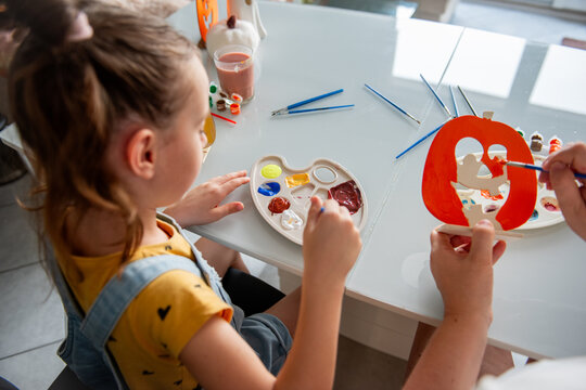 Mother and daughter make Halloween decorations at home