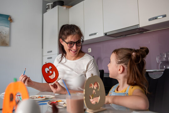 Mother and daughter make Halloween decorations at home