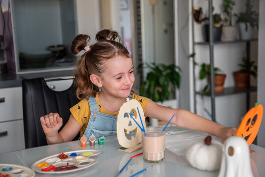 Mother and daughter create Halloween decorations at home