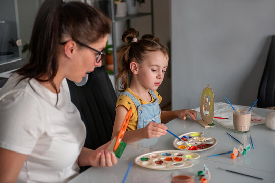 Mother and daughter make Halloween decorations at home