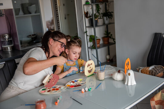 Mother and daughter make Halloween decorations at home