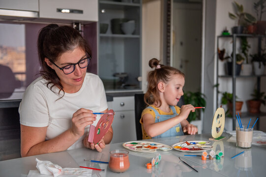 Mother and daughter create Halloween decorations at home