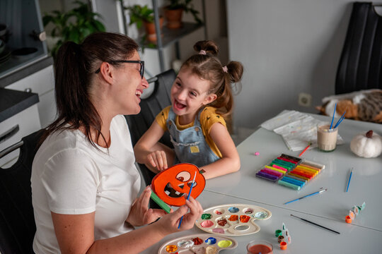 Mother and daughter make Halloween decorations at home