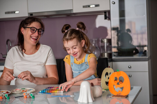 Mother and daughter create Halloween decorations at home