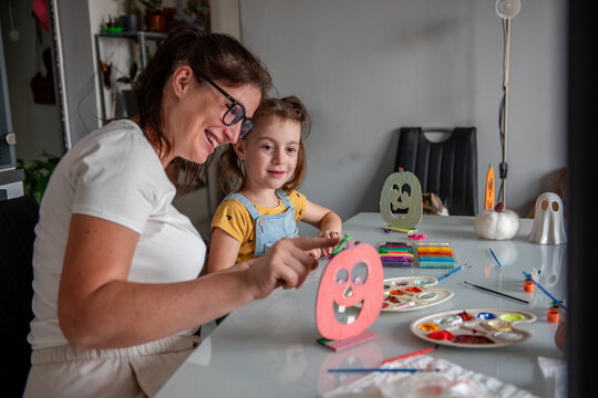 Mother and daughter create Halloween decorations at home