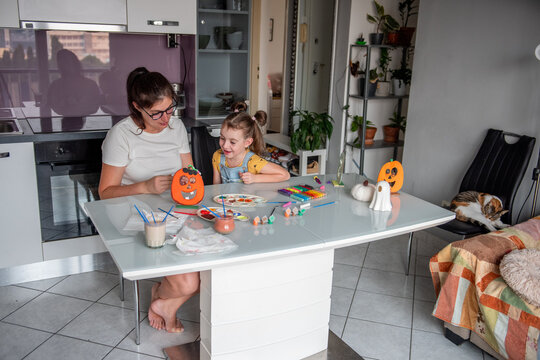 Mother and daughter create Halloween decorations at home