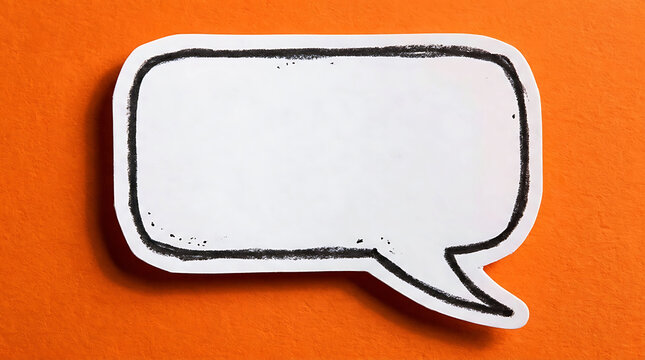 Blank white speech bubble on vibrant orange textured paper background