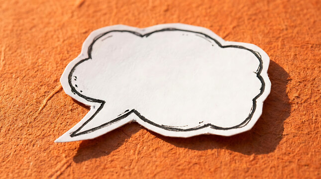 Blank speech bubble on orange textured paper background for text message layout