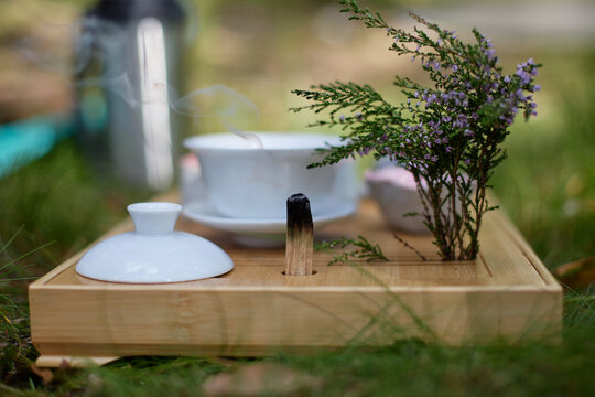 Chinese tea ceremony set with incense and flowering branch