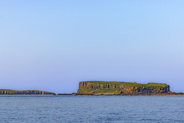 View from the sea onto Cairn na Burgh Mor and the Treshnish Isles, islands in the Inner Hebrides, off the west coast of the Isle of Mull in Scotland. © DirkR