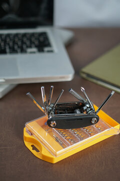 Compact multi-tool and screwdriver bit set on desk