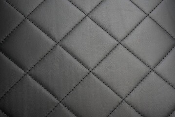 Obraz premium Close-up of Quilted Leather Upholstery with Diamond Pattern