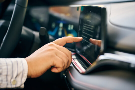 Driver use touchscreen infotainment system inside modern car