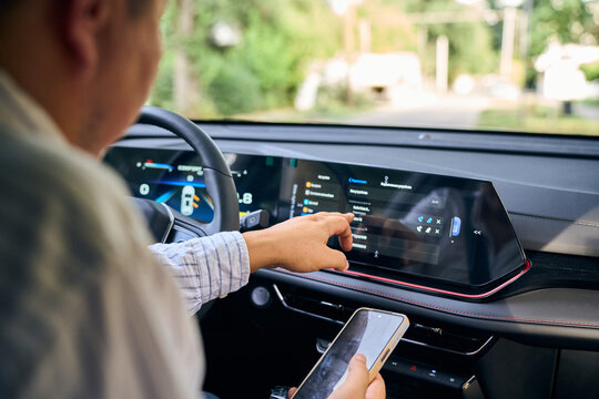 Driver uses car touchscreen infotainment system connection