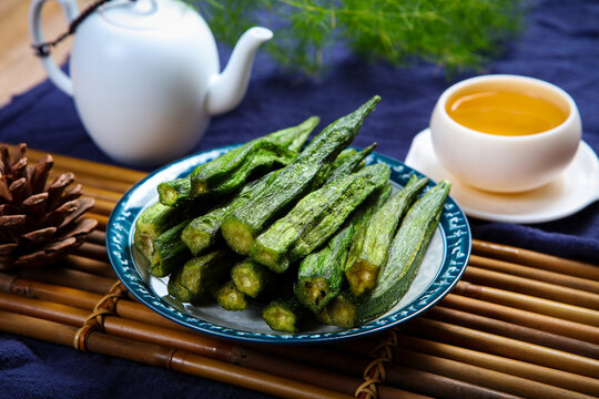 Dried crispy okra vegetable chips paired with white porcelain tea set