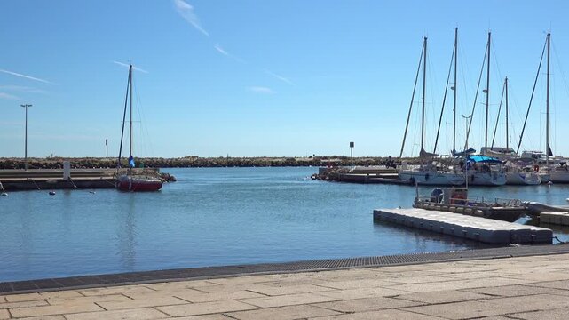 Boats are anchored in a marina on river Orb. Valras, France