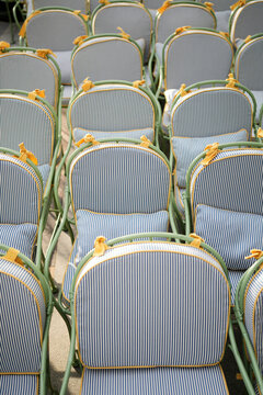 Empty Striped Bistro Chairs on Outdoor Restaurant Terrace