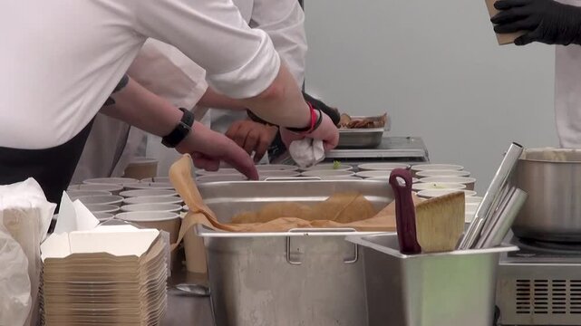 Chefs preparing food in an open street kitchen