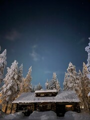 Small cabin at night in the middle of a snowy forest in Finnish Lapland, Finland © Vasyl  Diachuk