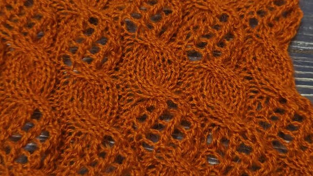 Multicolored hand-knitted fabric. Knitting and crochet lessons. Fashion and education. Training for artificial intelligence. Hands in the frame.