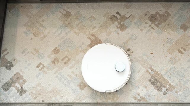 Automated robotic cleaning device navigates across a patterned carpeted floor surface while performing maintenance tasks during residential interior floor care operations