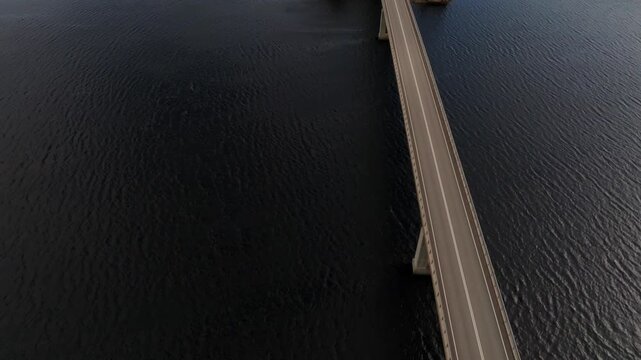 Aerial view following a car on bridge on Lietvesi scenic road in Saimaa Geo Park