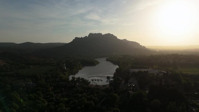 Aerial view rotating in front of the Roquebrune mountain, summer sunset in France