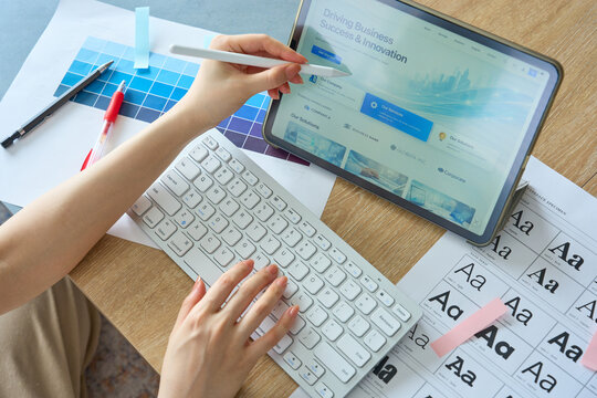 Woman's Hands Designing Website on Tablet with Stylus