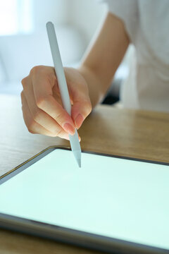 Young Womans Hand Writing on Digital Tablet with Stylus Pen