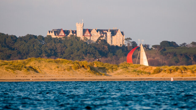 Sailboat passing Magdalena Palace in Santander, Spain