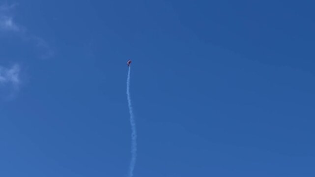 Aerobatic Biplane Performing Stunts with Smoke Trails at Gold Coast Airshow