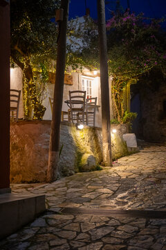 Cozy Outdoor Seating of Traditional Greek Tavern in Afionas Village Corfu with Fairy Lights on Trees