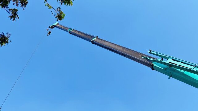 telescopic crane moving with blue sky background
