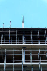 High rise building under construction with scaffolding © IbragimovN