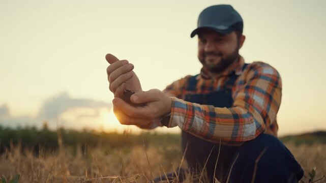 Happy farmer pouring soil in farmland, fertilizing agricultural fields, agronomy . Summer in countryside, traditional and innovative agriculture, professional farm worker, eco-farming and agribusiness