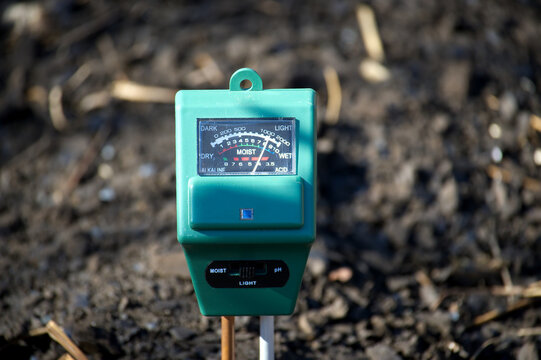 Gardening soil meter measuring moisture and light levels for plant growth