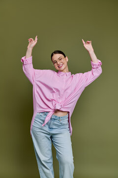 Stylish teenager showcases trendy vibes against an olive green backdrop