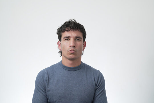 Young man making a pouting serious face