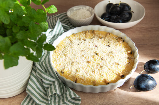 Baking plum crumble with fresh fruit and mint