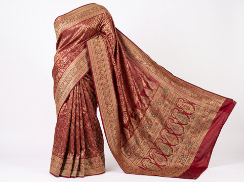 Traditional red and gold Indian saree draped elegantly on a mannequin  