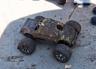 Muddy RC Monster Truck on Asphalt Ground © Andy