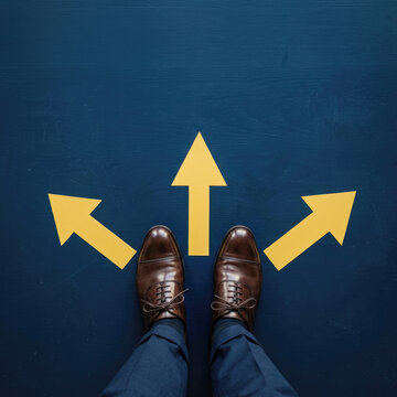 Businessman standing at crossroads deciding directional strategy from top view