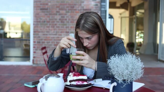 Food safety inspector carefully examines a drink using a portable testing device to detect suspicious substances during an unexpected quality control visit at a cafe today