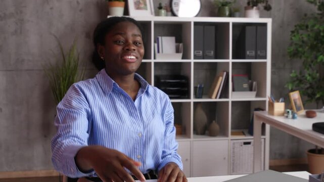 Two businesswomen shaking hands and finalizing a deal in an office