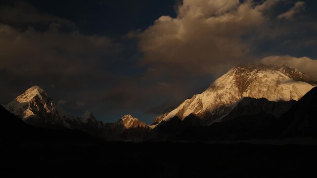 Timelapse of the dramatic Himalayan landscape in Nepal, showing rugged mountain valleys, snow-covered peaks and changing clouds and light.