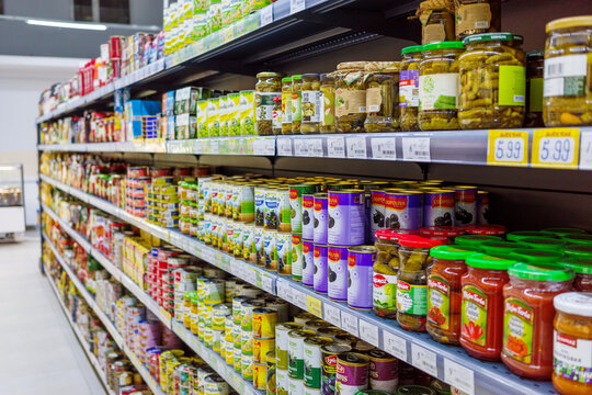 BATUMI, GEORGIA - SEPTEMBER 5, 2026: Supermarket aisle displays canned vegetables, sauces, preserved foods and grocery products with shelf prices in local store