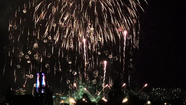 Dense golden fireworks pouring down with burning flame drops over the Seoul city skyline at night, above the Han River in South Korea