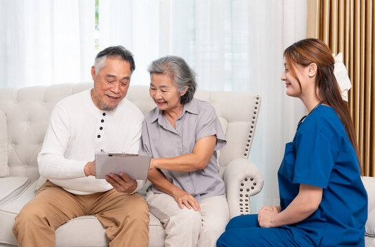 health care worker asking a senior patient signing informed consent during home health care